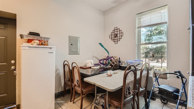 dining area featuring light tile patterned floors and electric panel