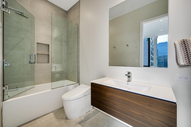 full bathroom with enclosed tub / shower combo, vanity, tile patterned floors, and toilet