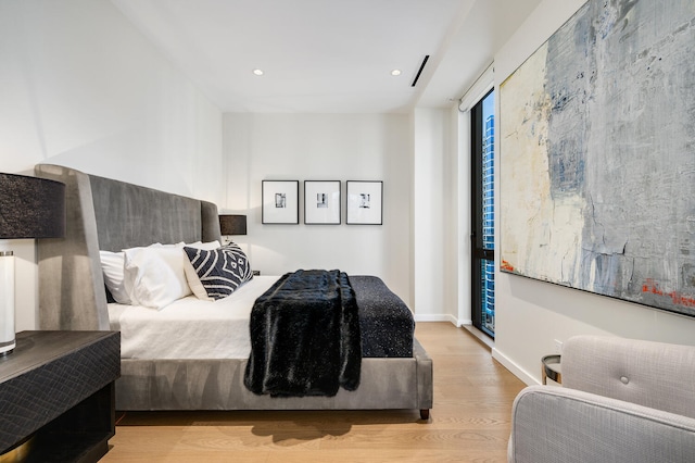 bedroom with light hardwood / wood-style flooring