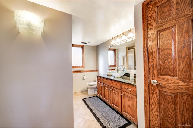 bathroom with tile patterned flooring, vanity, and toilet