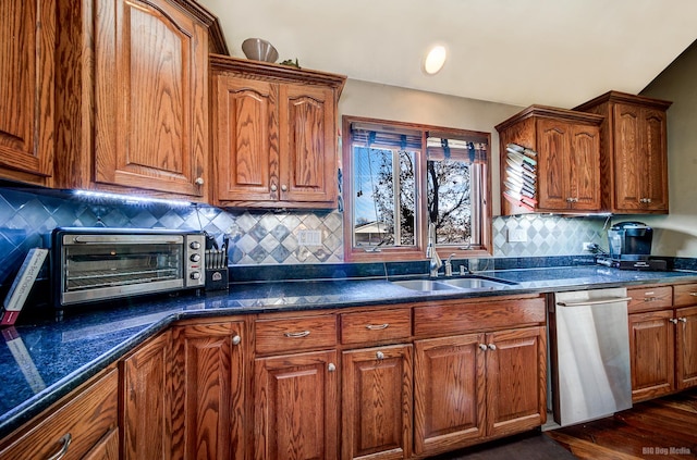 kitchen featuring dishwasher, sink, dark hardwood / wood-style floors, and decorative backsplash