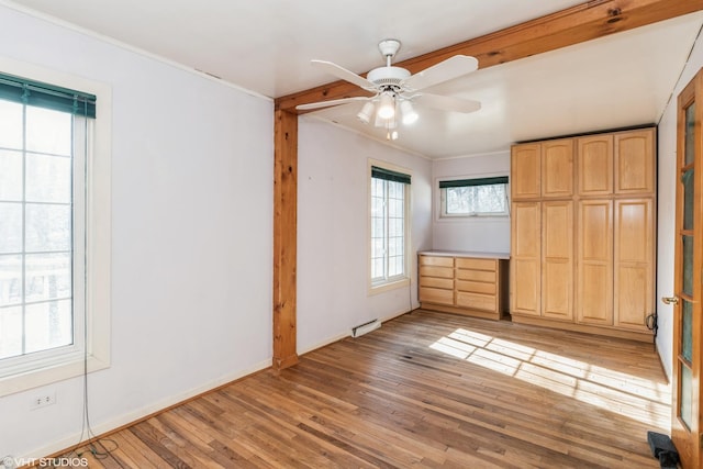 unfurnished bedroom featuring ornamental molding, ceiling fan, and light hardwood / wood-style flooring