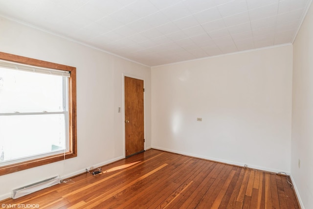 unfurnished room featuring hardwood / wood-style flooring and ornamental molding