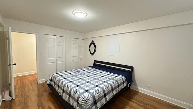 bedroom with dark hardwood / wood-style floors