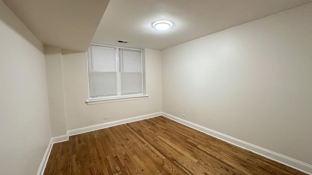 unfurnished room with hardwood / wood-style floors