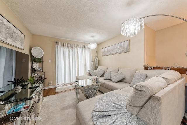 living room featuring a notable chandelier, hardwood / wood-style floors, and a textured ceiling