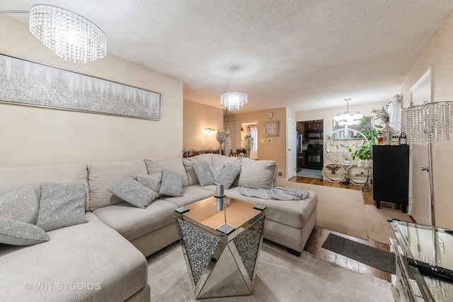 living room with a notable chandelier and a textured ceiling