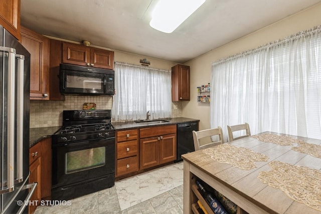 kitchen featuring sink, backsplash, and black appliances