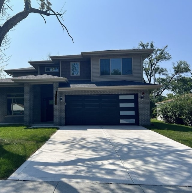 view of front of property featuring a garage and a front yard