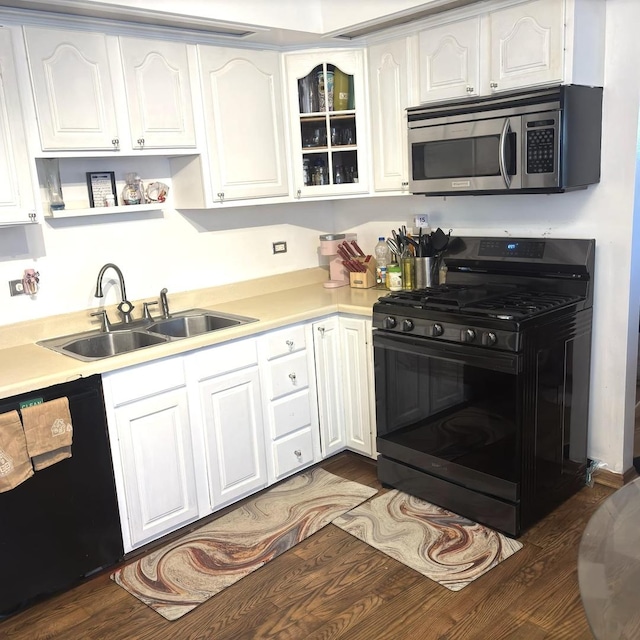 kitchen with black appliances, dark hardwood / wood-style floors, sink, and white cabinetry