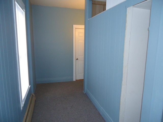 hallway with baseboard heating and carpet floors