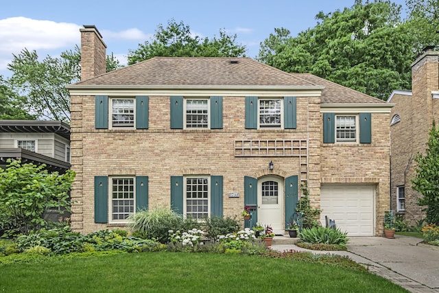 view of front of house with a garage and a front yard