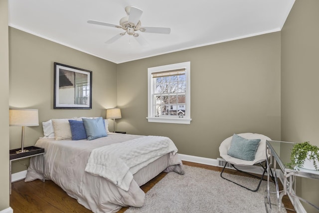 bedroom with crown molding, hardwood / wood-style floors, and ceiling fan