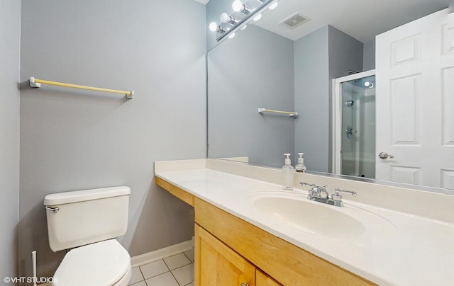 bathroom featuring tile patterned floors, vanity, toilet, and walk in shower