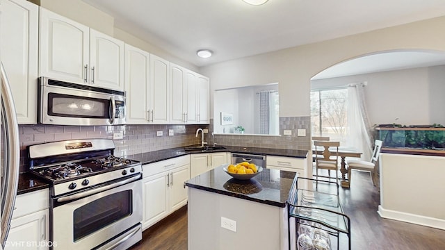 kitchen featuring sink, white cabinetry, a center island, and stainless steel appliances