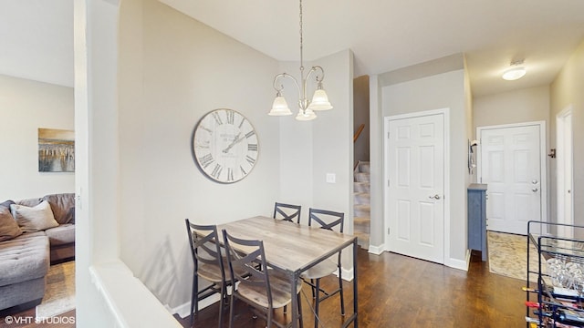 dining space with a chandelier and dark hardwood / wood-style flooring