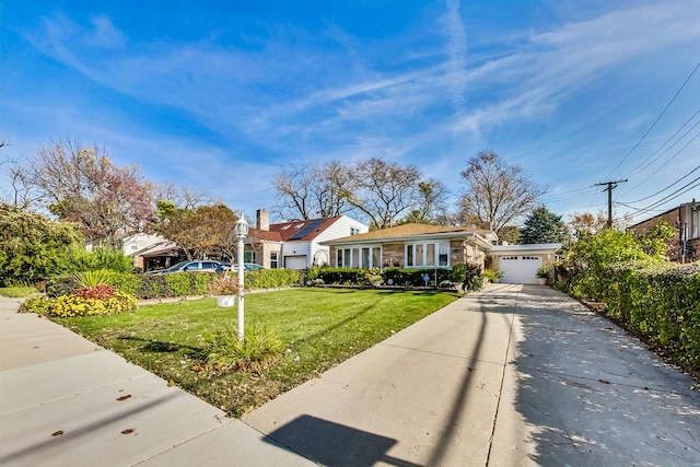 view of front of home with a garage and a front yard