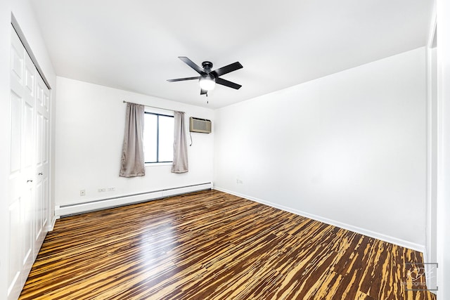 empty room with ceiling fan, a baseboard heating unit, dark hardwood / wood-style flooring, and a wall mounted air conditioner