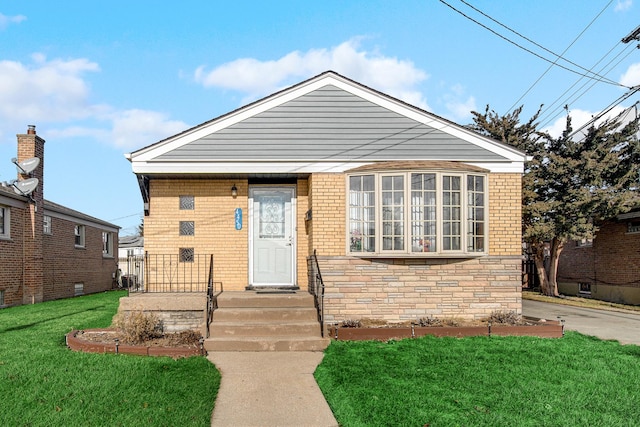 bungalow-style home with a front yard