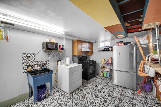 kitchen featuring black appliances and washer / clothes dryer