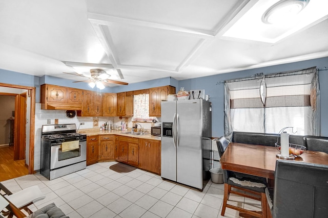 kitchen featuring light tile patterned floors, stainless steel appliances, ceiling fan, and sink