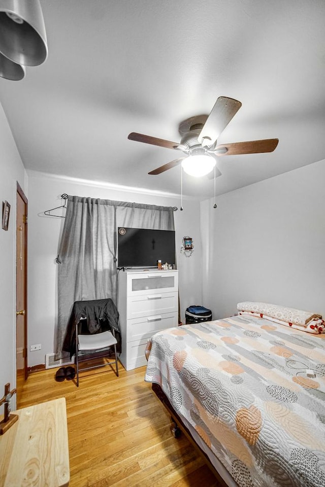 bedroom with ceiling fan and light hardwood / wood-style floors