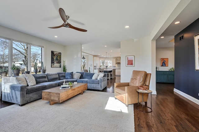 living room featuring hardwood / wood-style flooring and ceiling fan