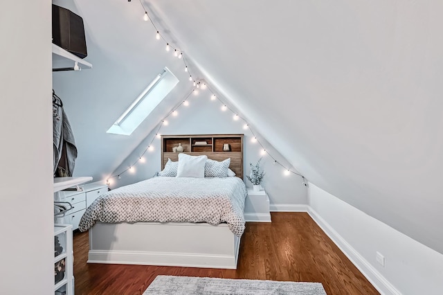 bedroom featuring dark wood-type flooring and lofted ceiling with skylight