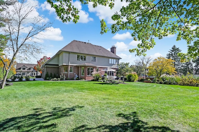 back of house featuring a yard