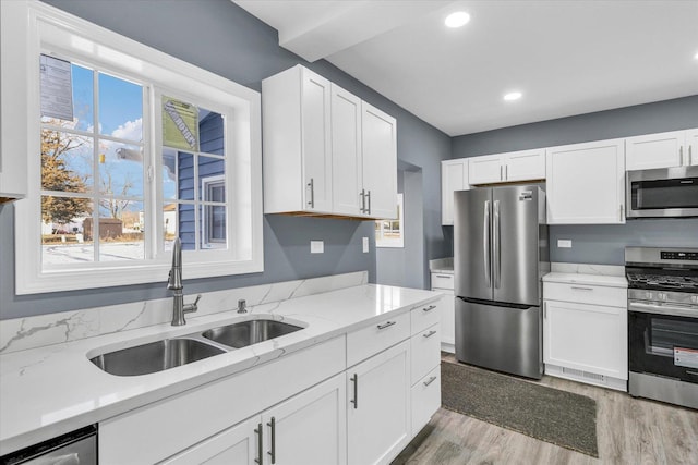 kitchen with white cabinets, sink, and stainless steel appliances