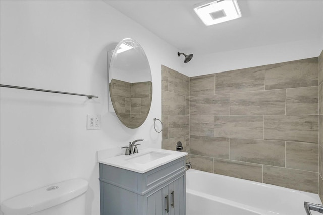 full bathroom featuring toilet, tiled shower / bath combo, and vanity