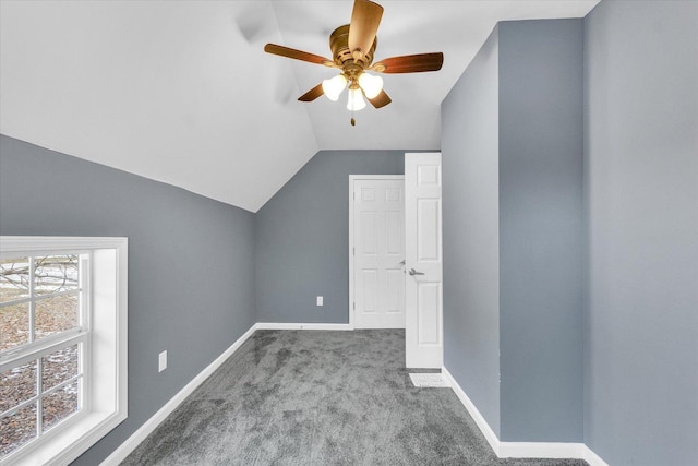 additional living space with carpet floors, a wealth of natural light, ceiling fan, and vaulted ceiling