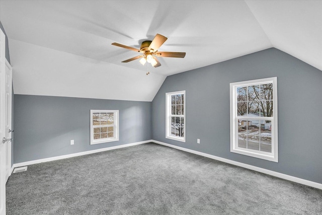 additional living space featuring ceiling fan, carpet, and lofted ceiling