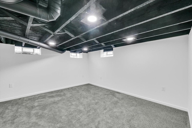 basement featuring plenty of natural light and carpet