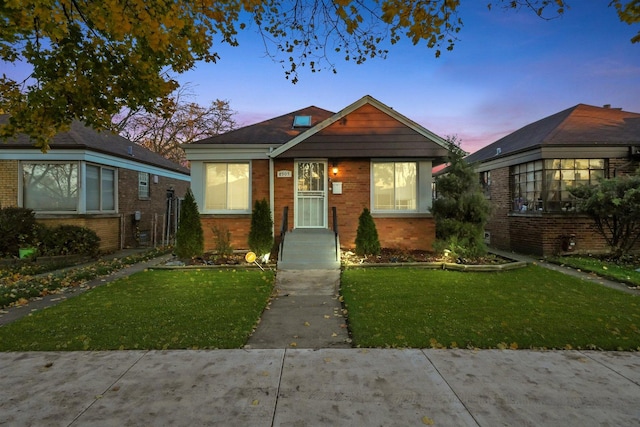 bungalow-style house featuring a lawn