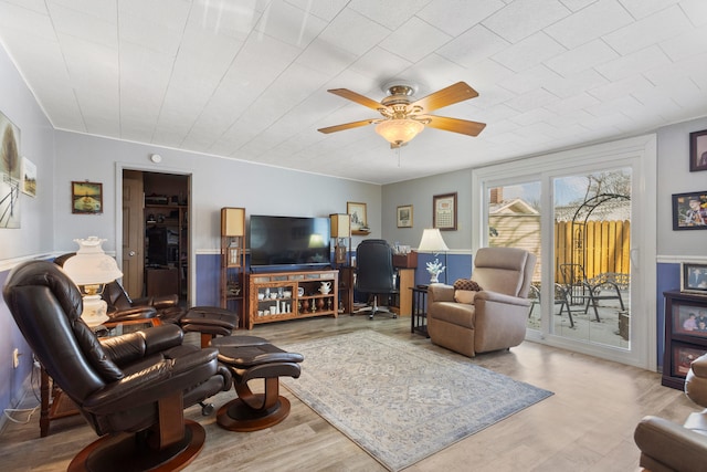 living room featuring ceiling fan and light wood-type flooring