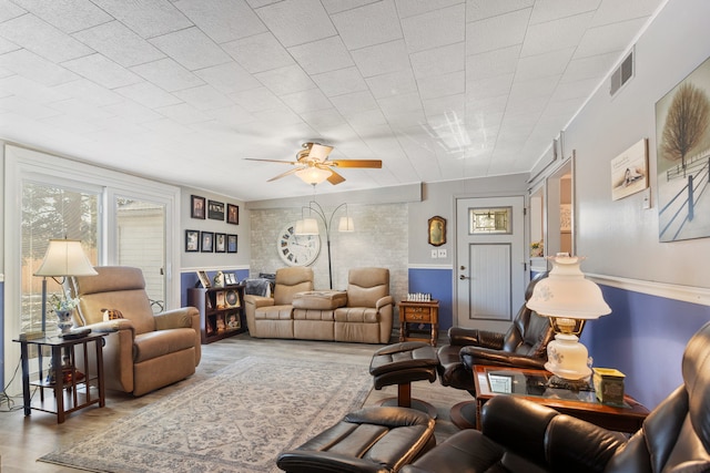 living room with wood-type flooring and ceiling fan