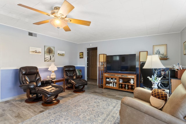 living room with wood-type flooring and ceiling fan