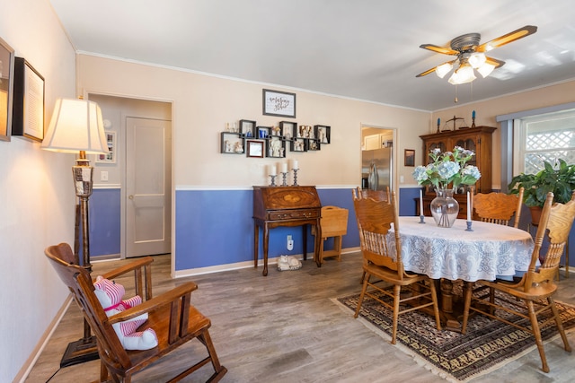 dining space with hardwood / wood-style flooring, ceiling fan, and ornamental molding