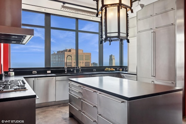 kitchen with sink, a center island, island exhaust hood, and stainless steel gas stovetop