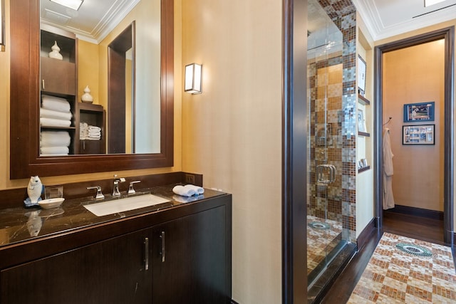 bathroom with vanity, crown molding, wood-type flooring, and walk in shower