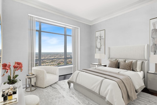 bedroom featuring hardwood / wood-style flooring and ornamental molding