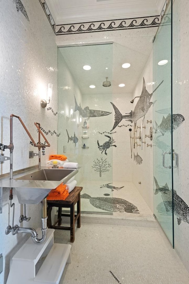 bathroom featuring a shower with shower door and crown molding