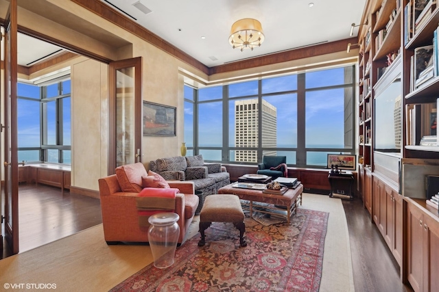 living room featuring a water view and dark hardwood / wood-style flooring