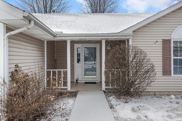 view of snow covered property entrance