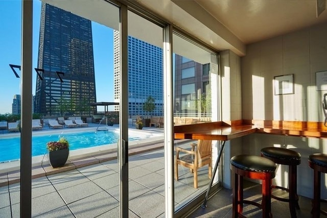 balcony with a patio area and a bar