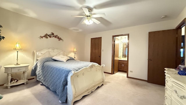 bedroom featuring ensuite bathroom, baseboards, a ceiling fan, and light colored carpet