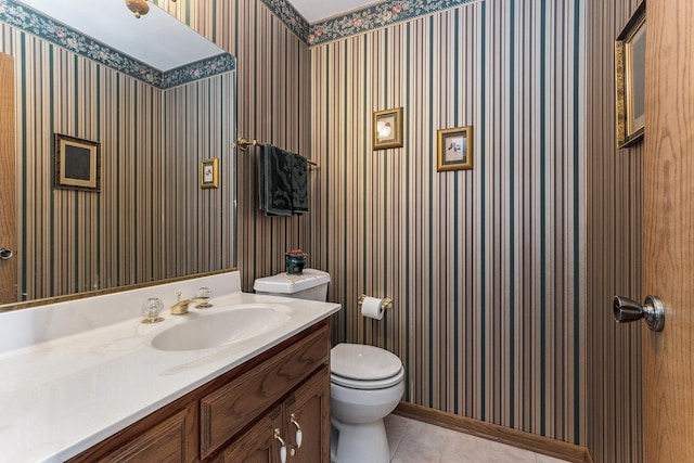 bathroom with tile patterned floors, vanity, toilet, and wallpapered walls