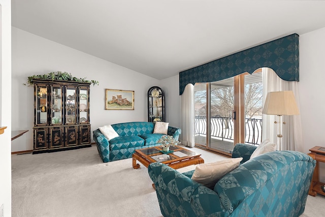 living area with carpet and vaulted ceiling