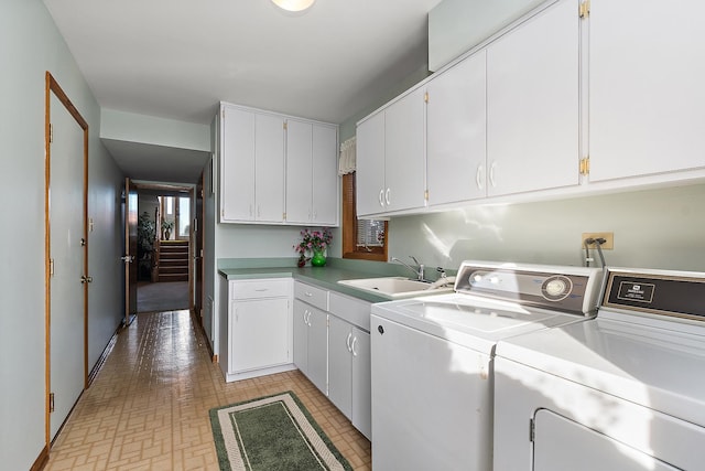 laundry room featuring cabinet space, a sink, and washer and clothes dryer